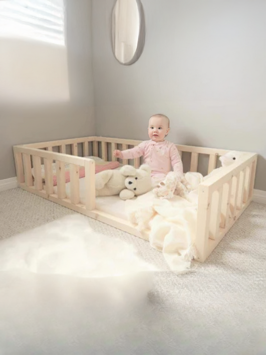 Child playing with stuffed animals in a wooden crib in a bright room.