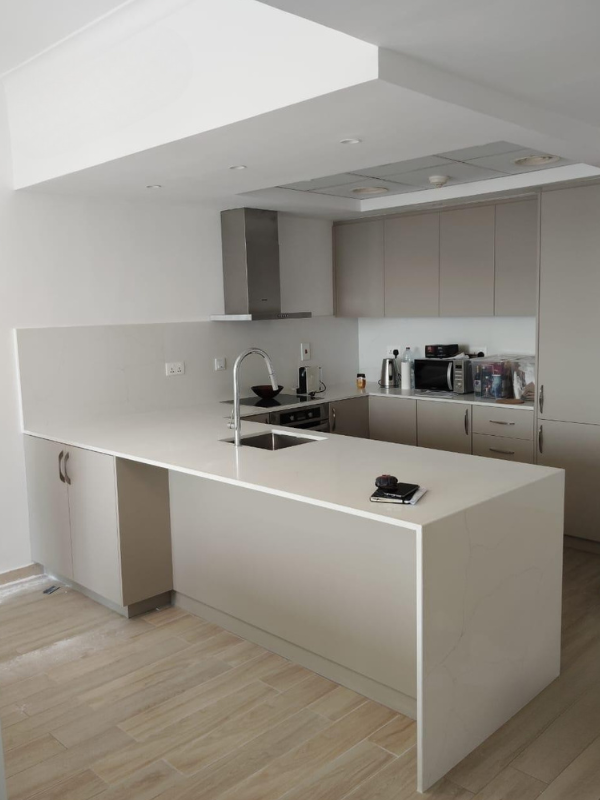 Open Kitchen with L-Shaped Quartz Countertop