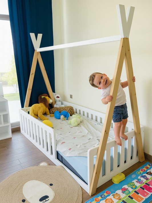 Child playing on a white teepee bed in a room with toys and a colorful rug.